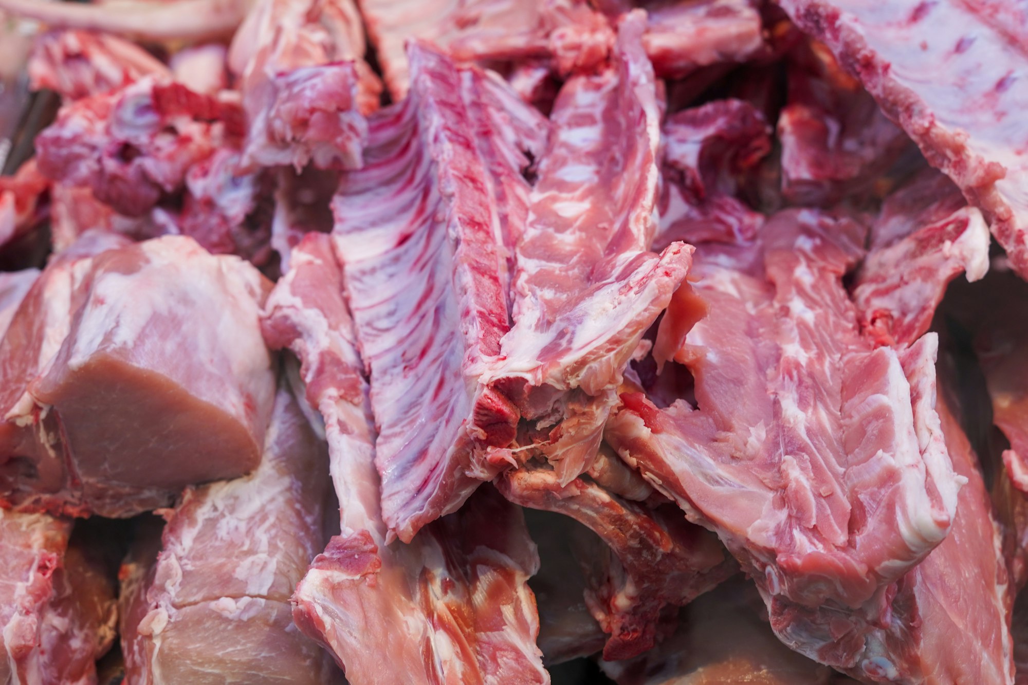 counter of a butcher's shop displaying various cuts of meat